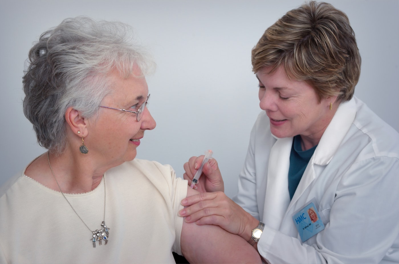 Nurse caring for a smiling elderly patient