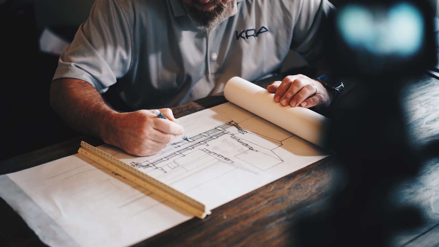 Engineer drafting on blueprints